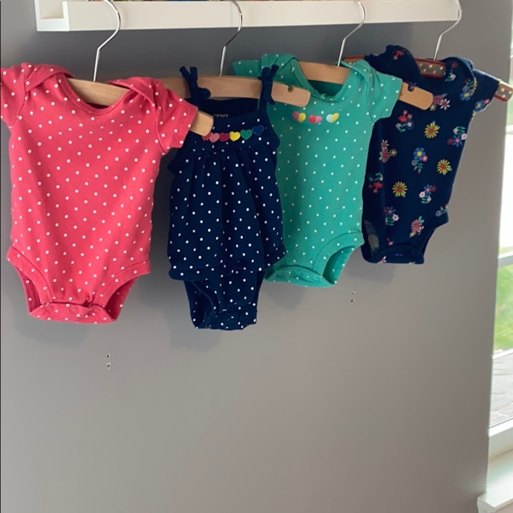 4 NB girls Carter’s brand onesies.